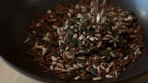 Close up of various seeds poured into a dish. Stock Footage 150122200