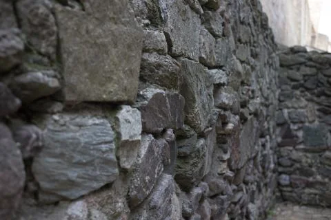 Close up of various shaped stone wall of medieval fortress. Stock Photos
