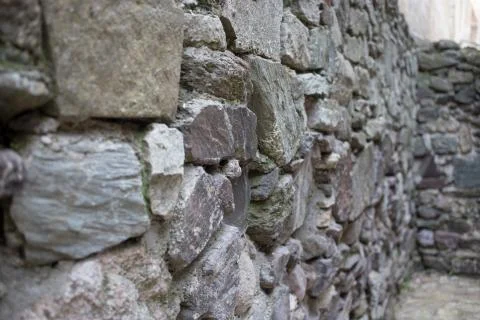 Close up of various shaped stone wall of medieval fortress. Stock Photos