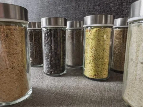 Close-up of various spice jars arranged in a group on a kitchen countertop Foto stock
