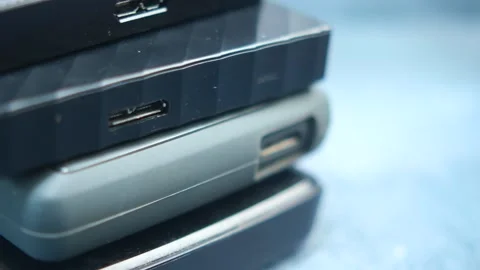Close-up of various tech gadgets stacked on a blue surface Stock Footage 303917721