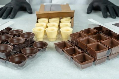 Close up of various types of chocolates in different shapes inside boxes. Stock Photos