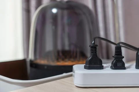 Close-up, Various types of power plugs are plugged into extension sockets. Stock Photos