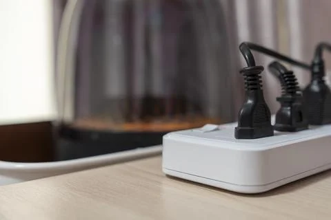 Close-up, Various types of power plugs are plugged into extension sockets. Stock Photos