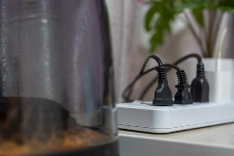 Close-up, Various types of power plugs are plugged into extension sockets. Stock Photos