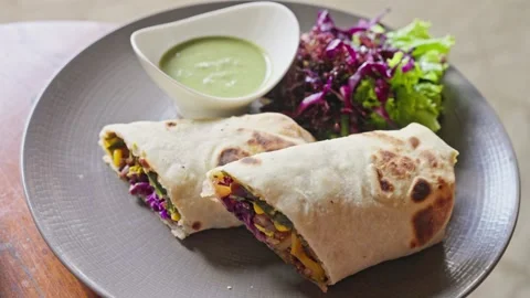 Close up. Vegan dish, vegetables wrapped in pita bread. corn, cabbage 库存影片 252037495