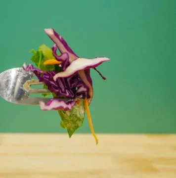 Close up Vegetable on fork with green background Stock Photos