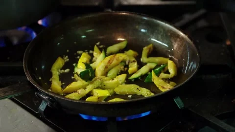 Close up vegetable sautee on gas stove in restaurant kitchen with sound Stock Footage 229808904
