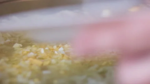 Close-Up of Vegetable Soup with Egg Being Added in Kitchen Pot 動画素材 334124194