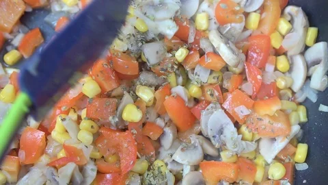 Close-up of vegetables are fried in a pan and stirred with a spatula Video stock 111956756