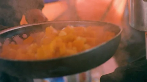 Close-Up of vegetables being tossed in a pan while cooking in a tent Video stock 113254479