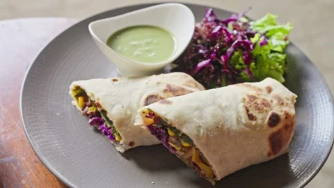 Close-up of vegetables, corn, cabbage wrapped in pita bread. Shawarma. Slow mo Stock Footage 251649765