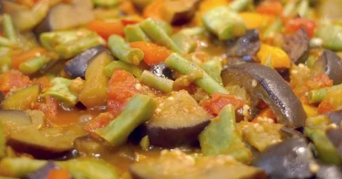 Close-up of vegetables simmering in oil Stock Footage 81799739