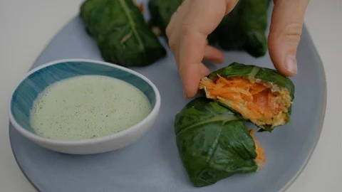 Close-up of veggie wrap with quinoa and vegetables on the blue plate Stock Footage 125296714
