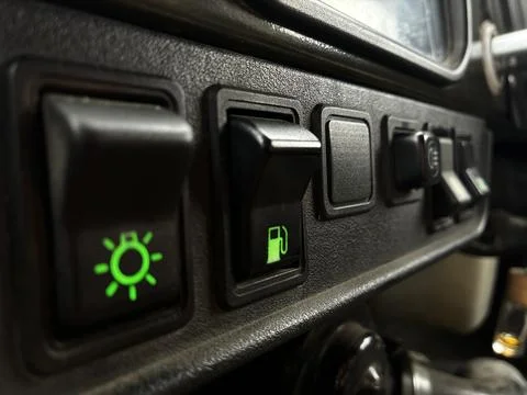 Close-up of vehicle dashboard control panel with illuminated green indicator lig Stock Photos