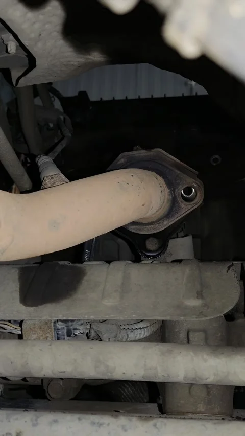 Close-up of vehicle underside exhaust system components in natural light Stock Footage 346638252