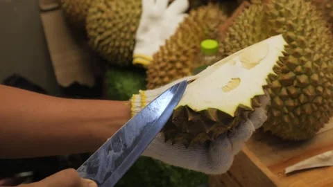 Close-up of Vendor Cutting Spiky Durian Fruit at Market Stall Stock Footage 345650490
