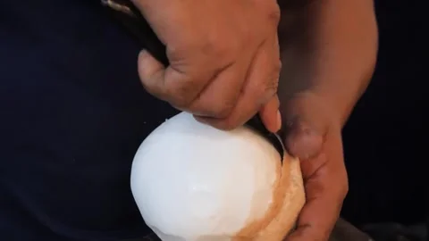 Close-up of Vendor Peeling a Fresh Young Coconut Ball Vídeo Stock 345644930