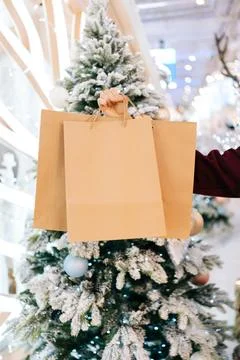 Close-up vertical cropped shot of unrecognizable man holding in hand paper bags Stock Photos