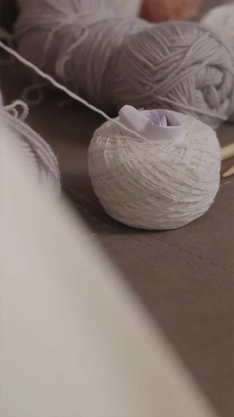 Close up vertical focus on a soft yarn ball during knitting Stock Footage 337451940