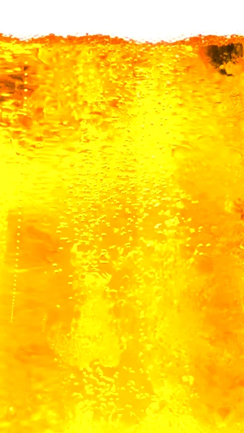 Close-up vertical footage of golden bubbles rising in a fizzy carbonated liquid. Stock Footage 312171252
