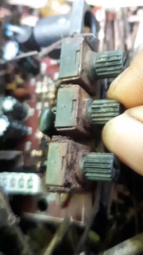 Close-up vertical footage showing hands trying to turn rusty electronic con.. Video stock 342628148
