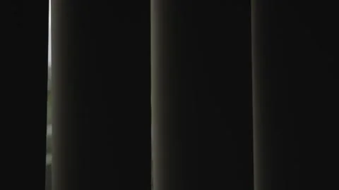 Close up on vertical modern window shades moving slowly revealing daylight Stock Footage 287301379