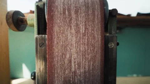 Close up of a vertical sanding or shaping machine pressing against a wooden Видео 334996216