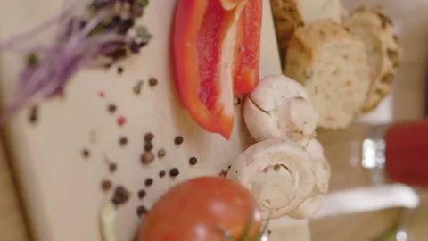 Close up vertical shot of mushrooms pepper tomato on wooden board. Fresh kitchen Stock Footage 144960726