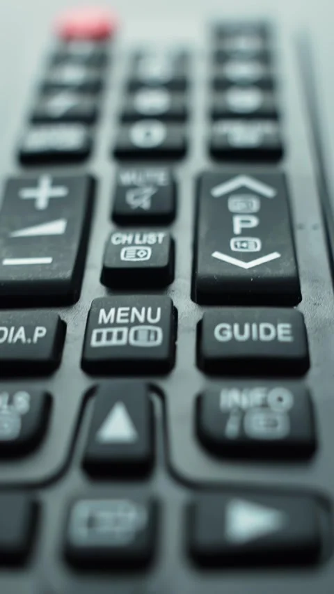 Close-up vertical shot of a TV remote control as the camera moves from bottom 스톡 동영상 329594827
