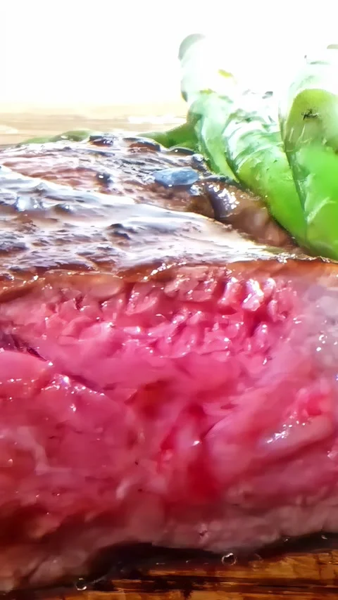 Close-up vertical social ratio video of a medium rare cooked steak and leafy Stock Footage 337093109