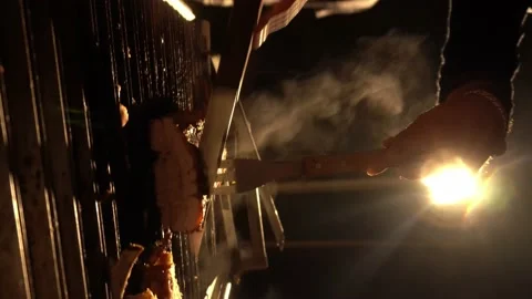 Close-up vertical video cutting pork prepared in the Chinese box on a grill with Stock Footage 199535402