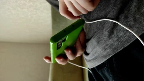 Close-up vertical video a hands of man holding smartphone. Video stock 154328982