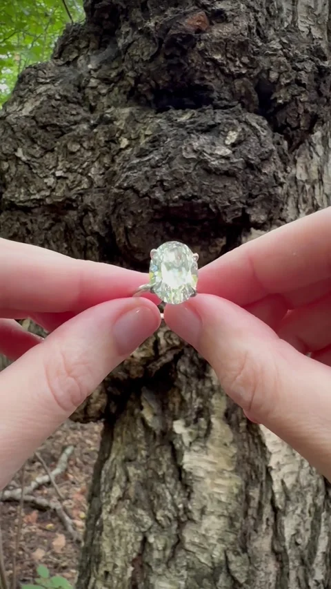 Close up vertical video of oval diamond engagement ring in daylight Stock Footage 316770949