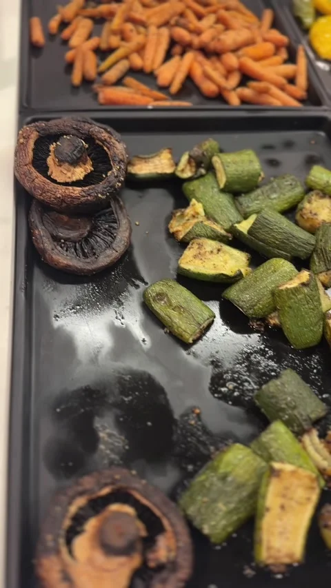 Close-up vertical video of roasted shiitake and zucchini pieces Stock Footage 322967660
