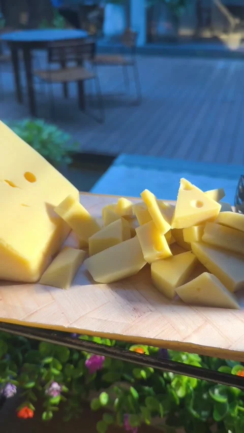 Close-up vertical video of yellow cheese block with sliced pieces Stock-Footage 322967473