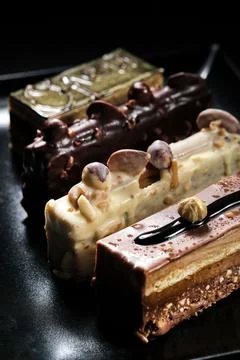 Close up vertical view four diverse chocolate desserts in plate Stock Photos