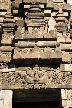 Close vertical view highlights an ornamental stone lintel and weathered mas.. Photos