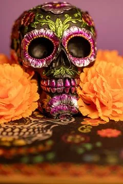 Close-up vertical view of a skull adorned with metallic floral decorations,.. Stock Photos
