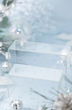 Close vertical view of transparent acrylic podiums in frosty winter decor f.. Fotos Stock
