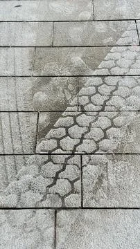 Close vertical view of a wet tyre tread on paving stones Stock Photos