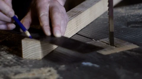 Close up very close hands of a carpenter marking the cutting line with carpenter Stock Footage 88656524