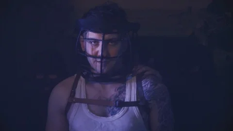 Close up of a very dangerous prisoner with restraining helmet on his head, being Stock Footage 104034804