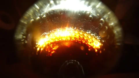 A close-up of a vessel with a bright orange-red element at the base Stock Footage 328596093