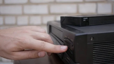 Close up of VHS tape being ejected from VCR. Black vintage video tape player. Stock Footage 69798202