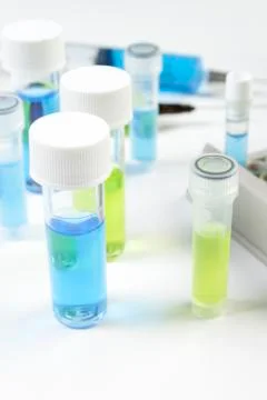 Close up of vials containing blue and green fluids Stock Photos