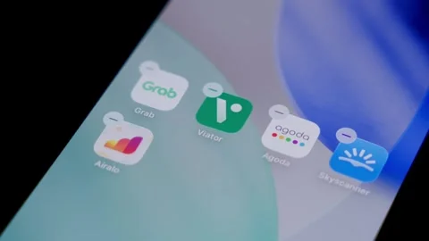 Close-up of the Viator app being deleted from a smartphone home screen in a Stock Footage 337239613