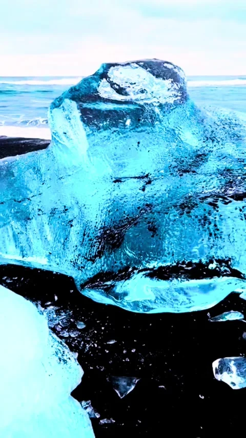 Close Up of a Vibrant Blue Iceberg Floating in Dark Arctic Water Stock Footage 331504928