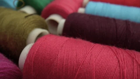 Close-up of vibrant colorful sewing thread spools on wood. Stock Footage 337138396