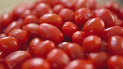 Close-up of vibrant, fresh red grape tomatoes grouped together Stock Footage 296323057